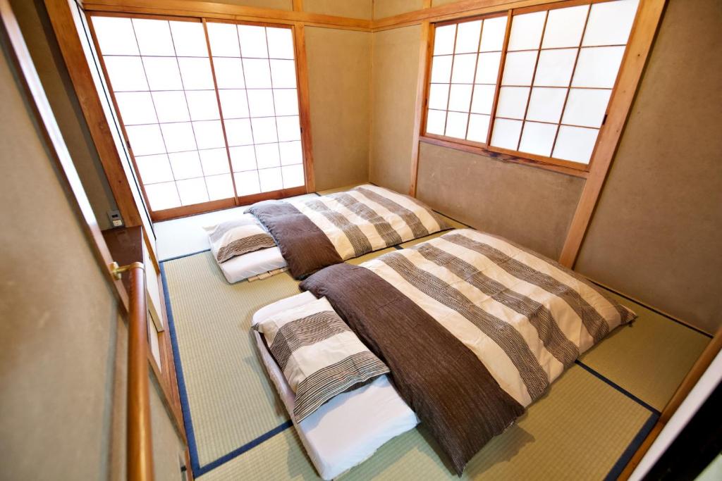 Postel nebo postele na pokoji v ubytování Gunma House