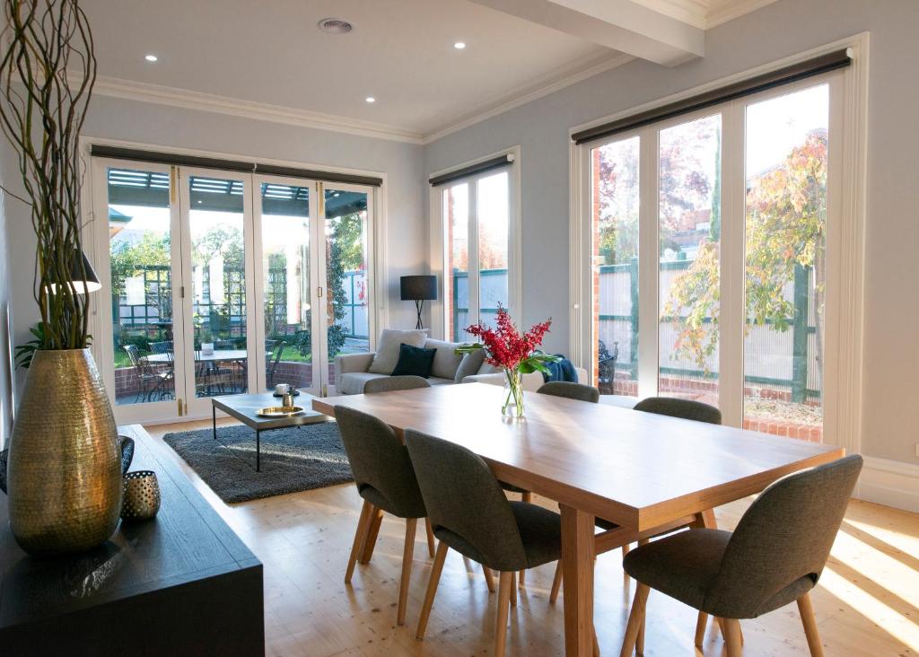 a living room with a wooden table and chairs at House at No. 10 in Ballarat