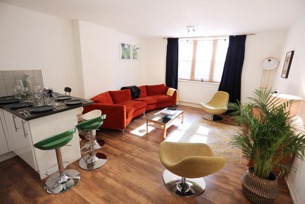 a living room with a red couch and chairs at 3beds/2baths in Oxford Circus in London