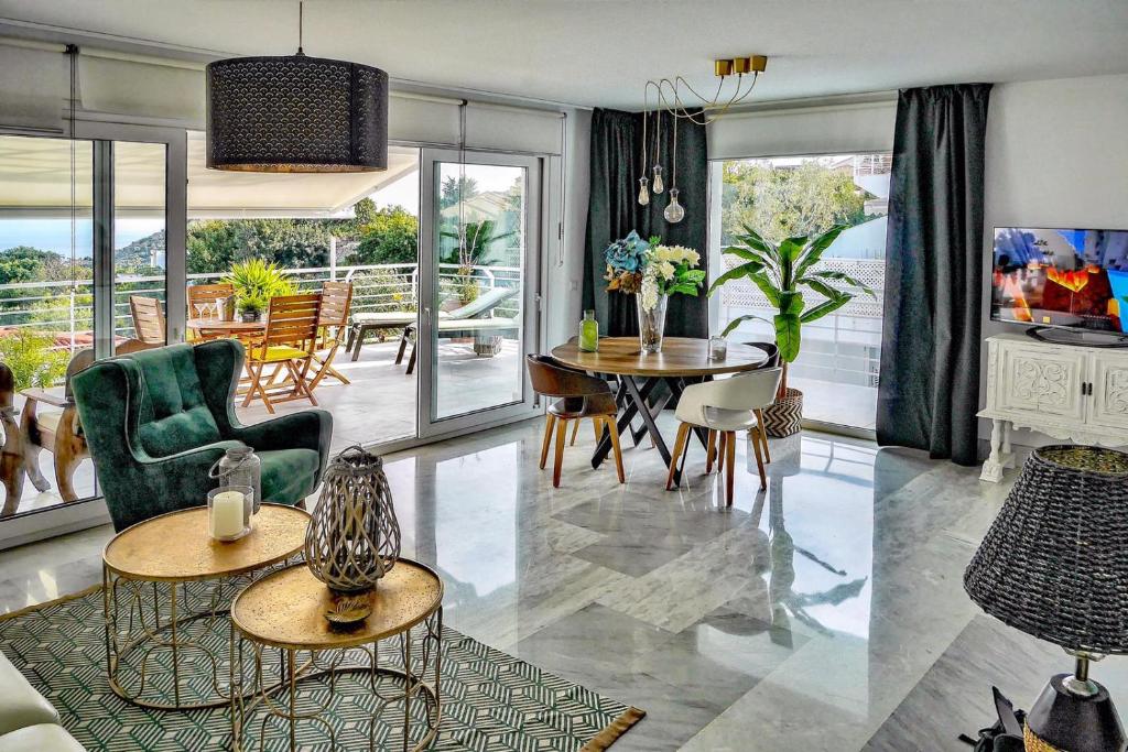 a living room with a table and chairs at PANORAMIC HOME in Benalmádena