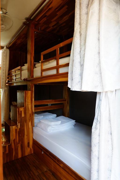 a couple of bunk beds in a room at Bloom Cafe & Hostel in Ko Lipe
