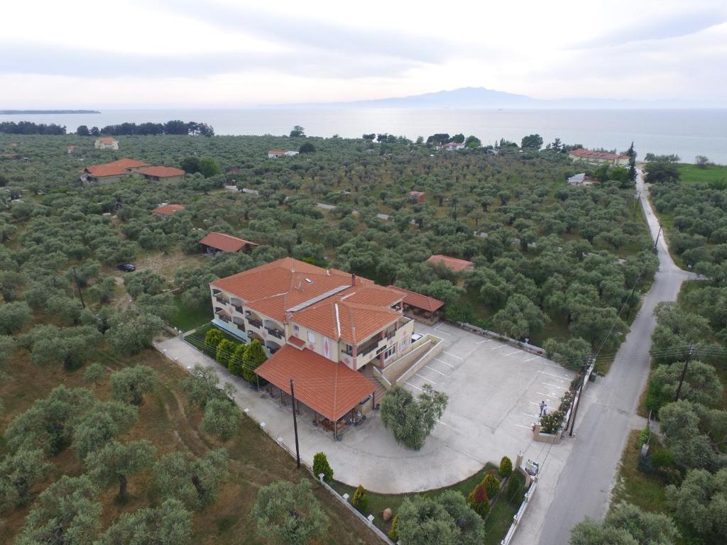 an aerial view of a house with a lot of trees at Iraklis Hotel in Skala Rachoniou