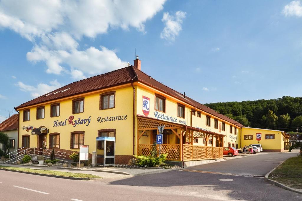 a yellow building on the side of a street at Hotel Ryšavý in Vémyslice