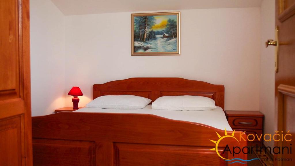 Postel nebo postele na pokoji v ubytování Apartmani Kovačić
