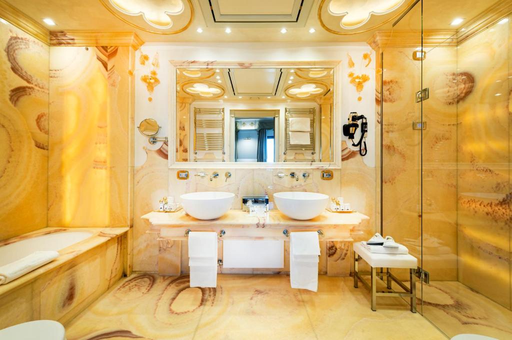 a bathroom with two sinks and a shower at Monaco &amp; Grand Canal in Venice