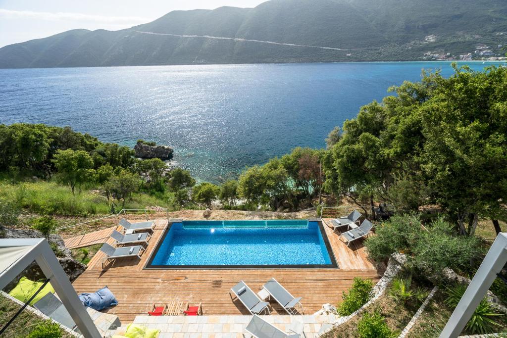 a swimming pool with a view of a lake at Soul Beach Suites in Vasiliki
