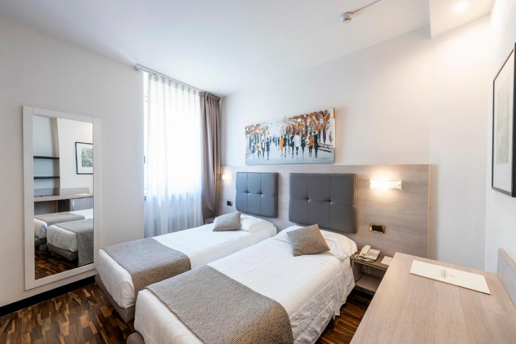 Postel nebo postele na pokoji v ubytování Hotel Asnigo