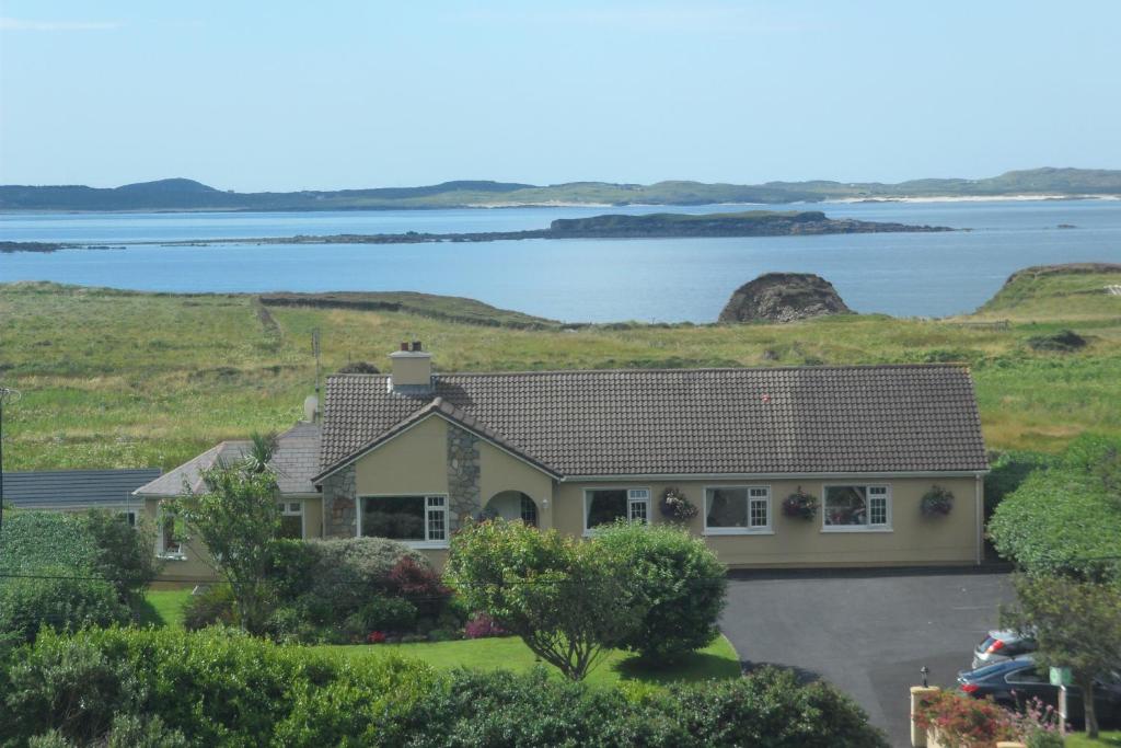a house with a view of the water at Rockmount House B&B in Clifden