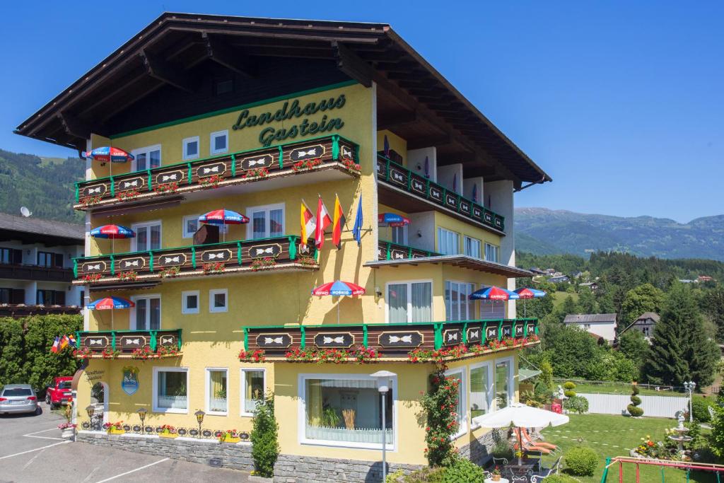 a yellow building with a sign on the side of it at Landhaus Gastein in Seeboden