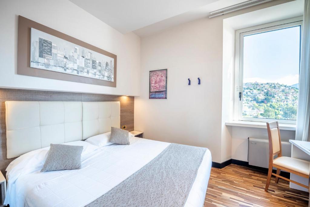 Postel nebo postele na pokoji v ubytování Hotel Asnigo