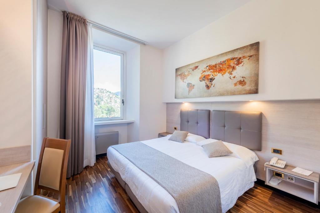 Postel nebo postele na pokoji v ubytování Hotel Asnigo