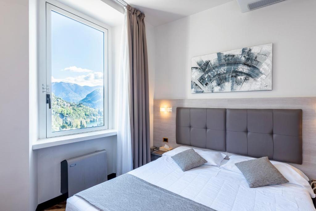 Postel nebo postele na pokoji v ubytování Hotel Asnigo