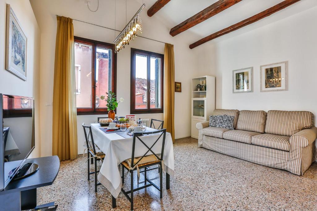 a living room with a table and a couch at Ca' Dell'Abate Terrace in Venice