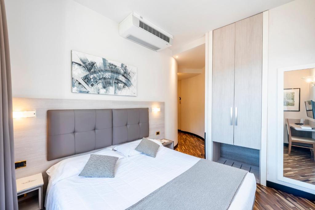Postel nebo postele na pokoji v ubytování Hotel Asnigo