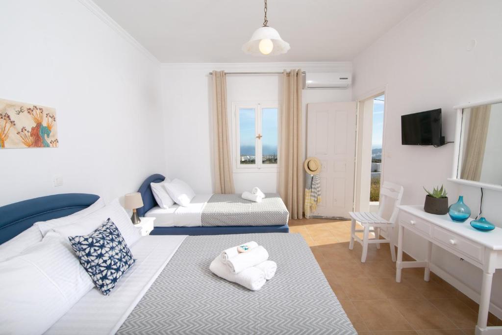 Postel nebo postele na pokoji v ubytování Caldera Sunset Villa