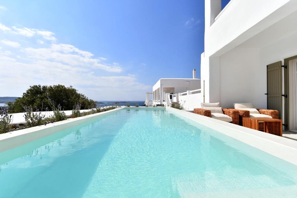 a large swimming pool on the side of a building at Ciel Villas Paros in Pounda