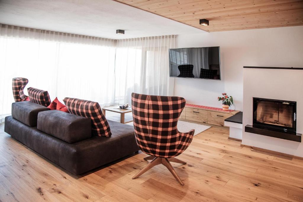 ein Wohnzimmer mit einem Sofa und einem Kamin in der Unterkunft Penthouse Chalet Pichlerhof in Bruneck