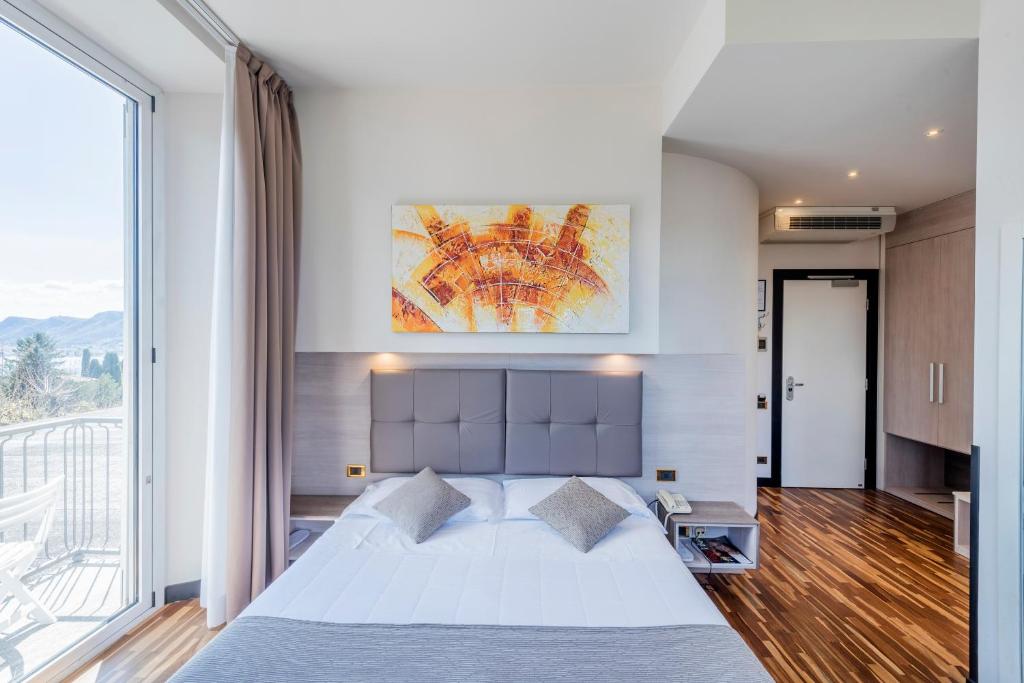 Postel nebo postele na pokoji v ubytování Hotel Asnigo