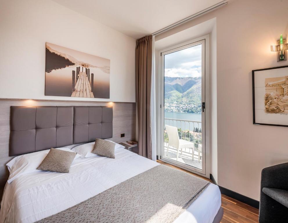 Postel nebo postele na pokoji v ubytování Hotel Asnigo