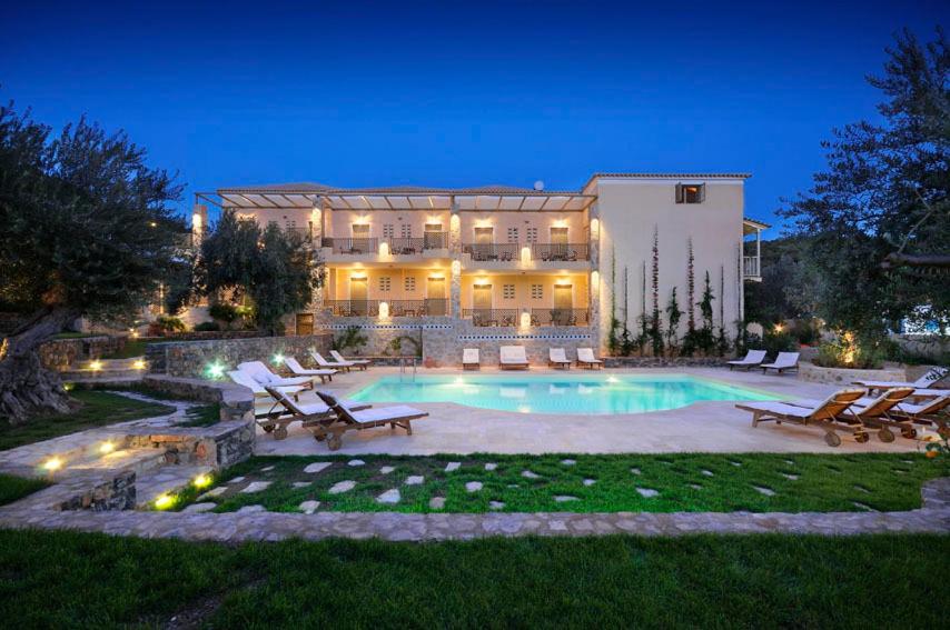 a large house with a swimming pool in the yard at Eleonas Studios in Poros