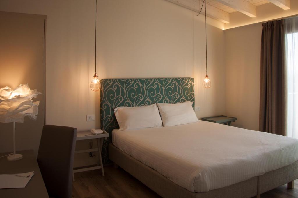 Postel nebo postele na pokoji v ubytování Hotel Berta