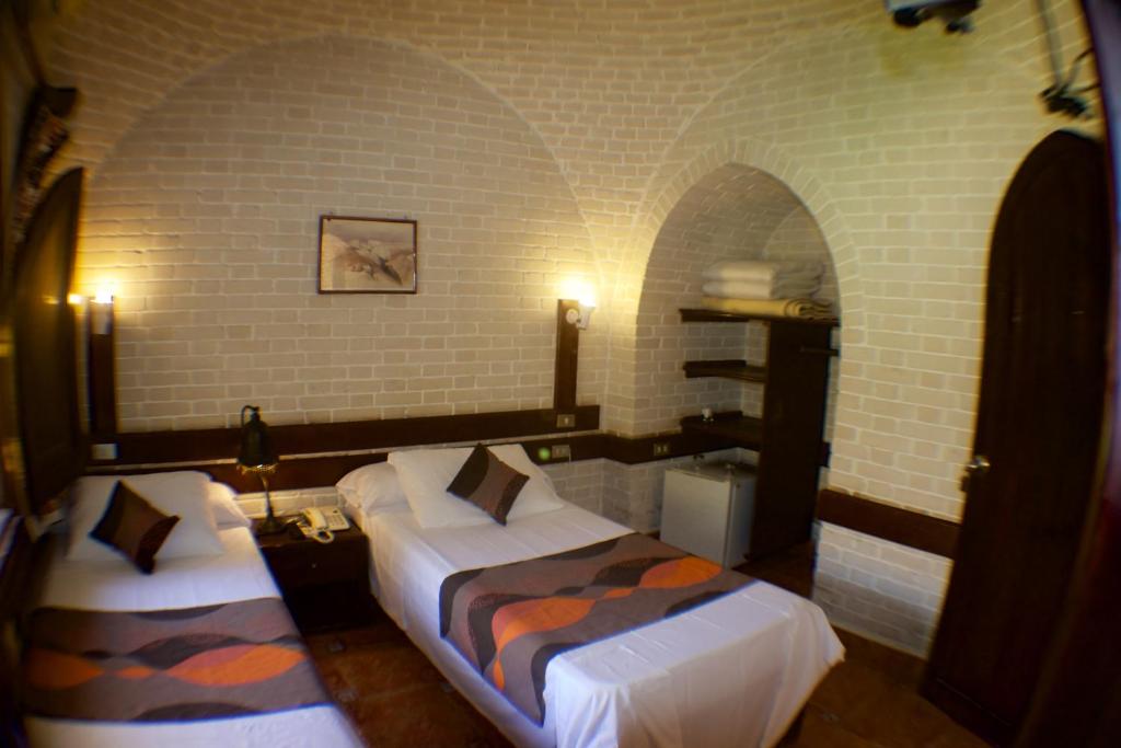 A bed or beds in a room at Nesima Resort