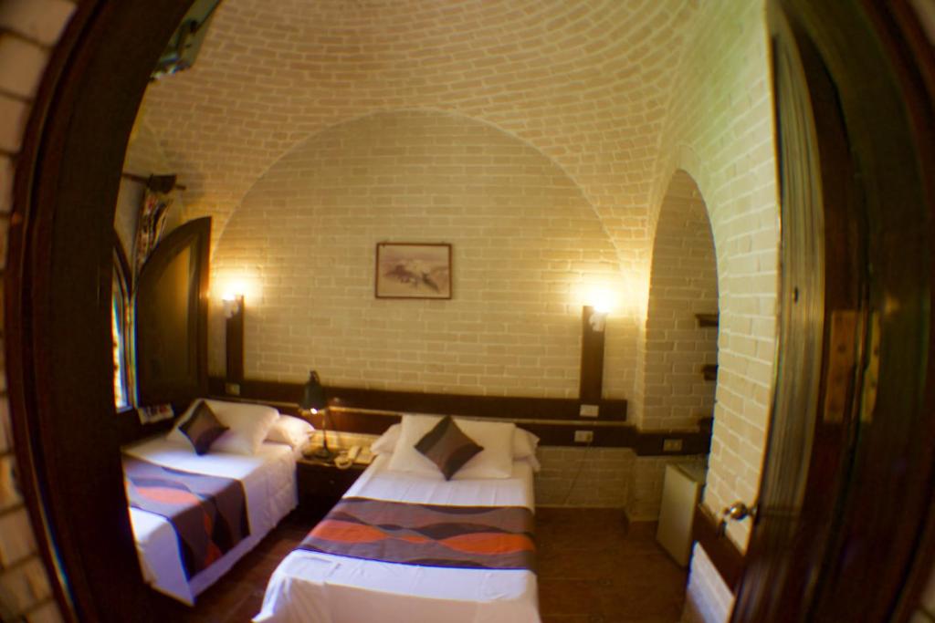 A bed or beds in a room at Nesima Resort