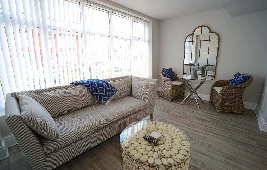 a living room with a couch and a table at Twelve Apartments in Blackpool