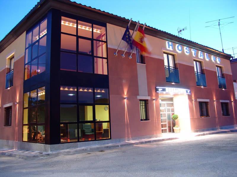 a large building with windows and flags in front of it at Buenavista in Cuenca