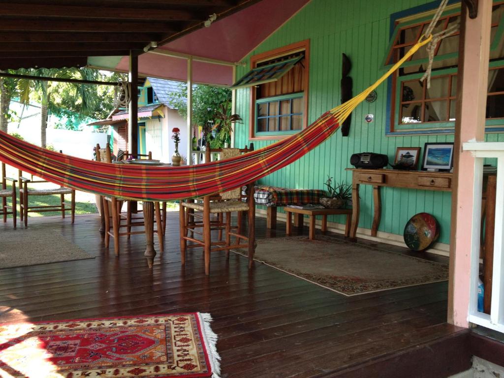 a hammock in a house with a table and chairs at Creole house 2 bedrooms with garden Best View Rodney Bay 21 in Gros Islet