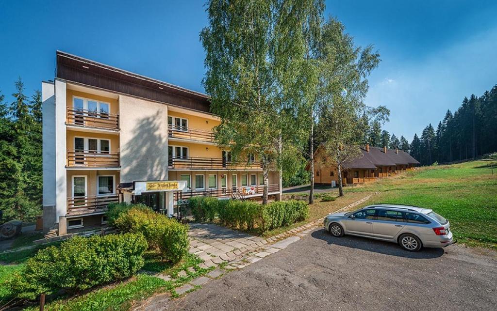 a car parked in front of a building at Penzion Limba in Liptovský Ján