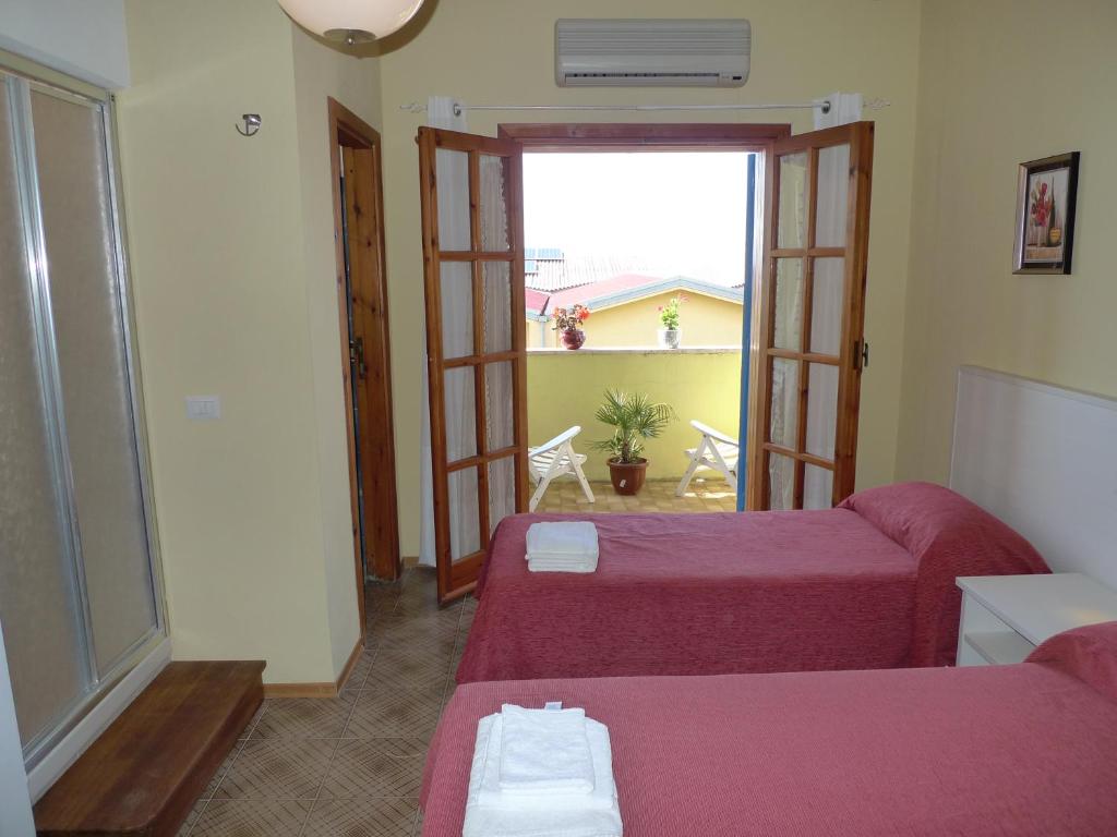 Postel nebo postele na pokoji v ubytování Hotel Alexander