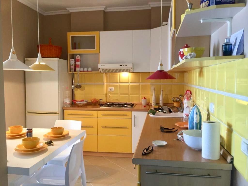 a kitchen with white cabinets and a counter top at Beach View! Seaside Apartment in Durrës