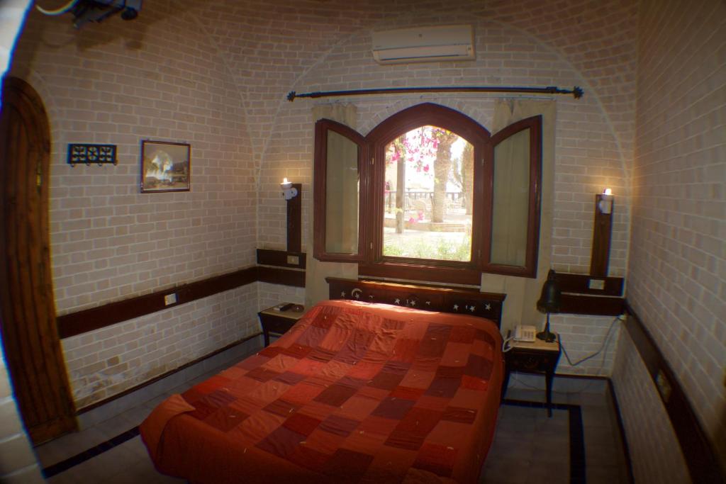 A bed or beds in a room at Nesima Resort