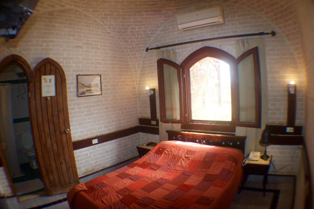 A bed or beds in a room at Nesima Resort