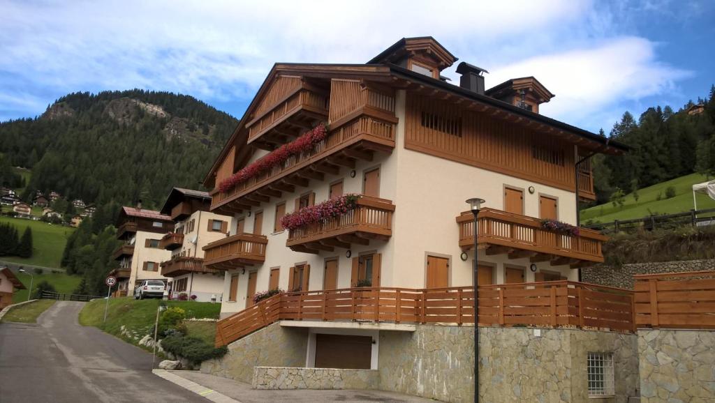 a building with balconies on the side of a road at Vista Pelmo in Colle Santa Lucia