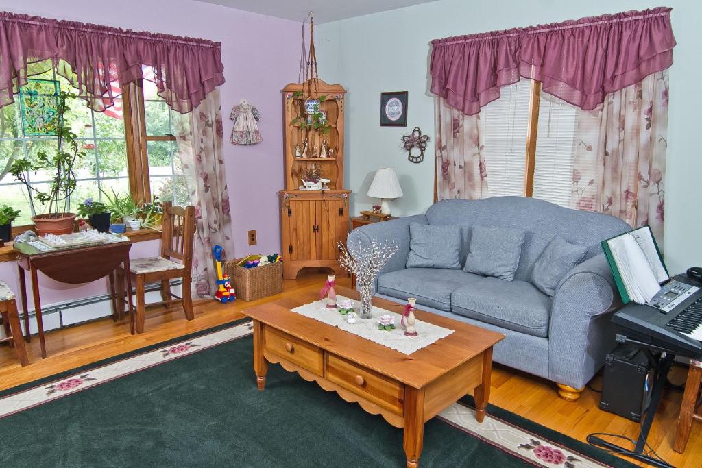 a living room with a blue couch and a coffee table at Pilgrim's Rest Bed and Breakfast in Philadelphia