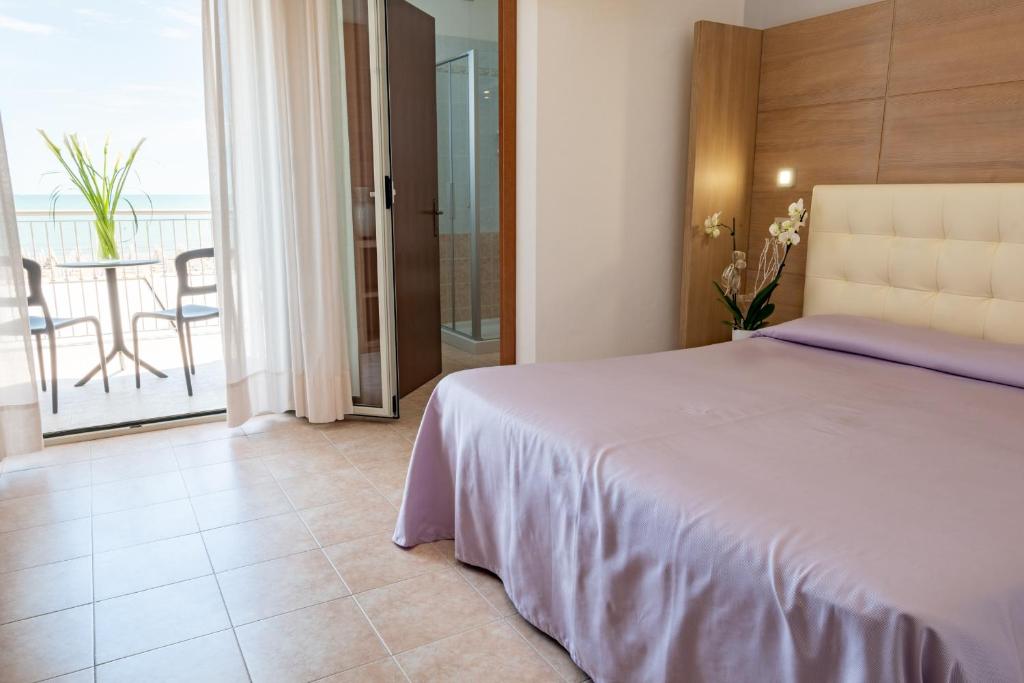 Postel nebo postele na pokoji v ubytování Hotel Nettuno