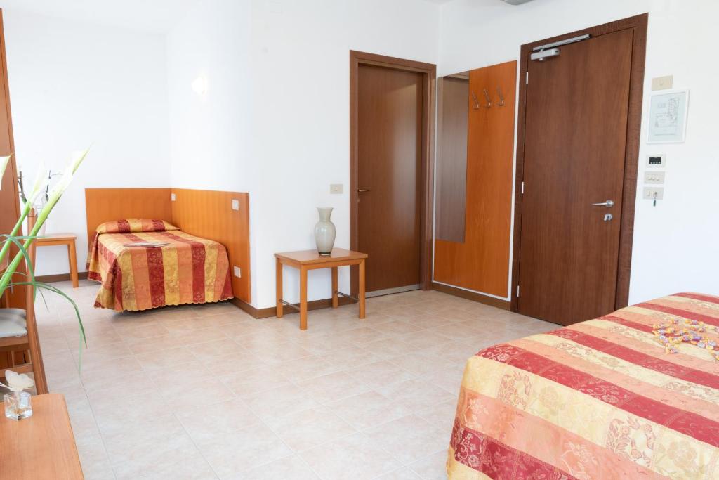 Postel nebo postele na pokoji v ubytování Hotel Nettuno