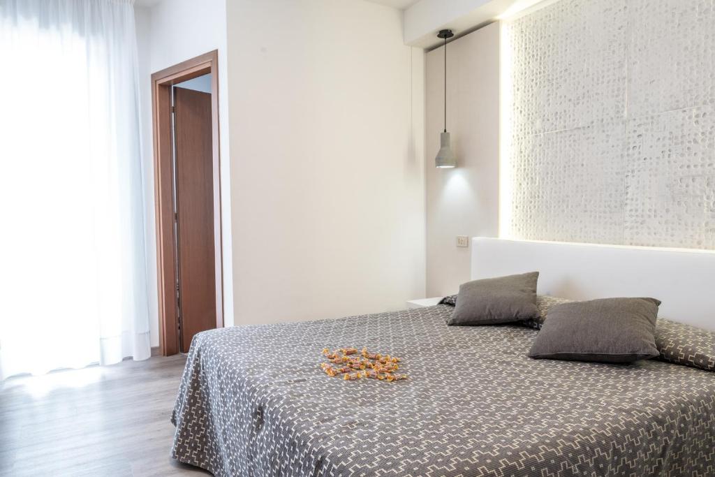 Postel nebo postele na pokoji v ubytování Hotel Nettuno