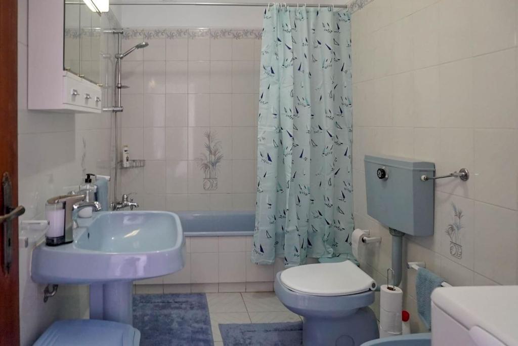 a bathroom with a sink and a toilet and a shower at Studio Apartment with Sea View & Fibre Internet in Albufeira