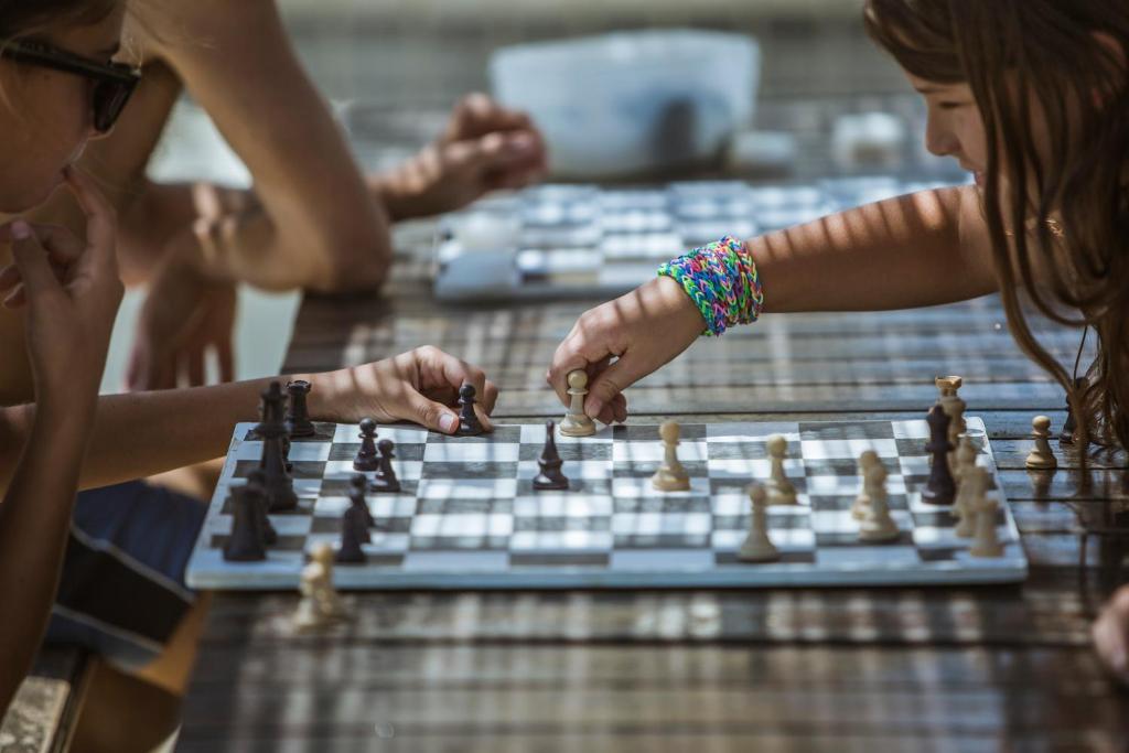 een groep mensen die een schaakspel spelen bij Hotel Eden in Rimini