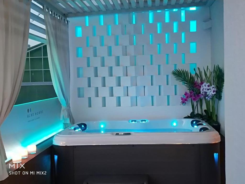 a bathroom with a tub with blue lights on it at Alke Homme II in Athens