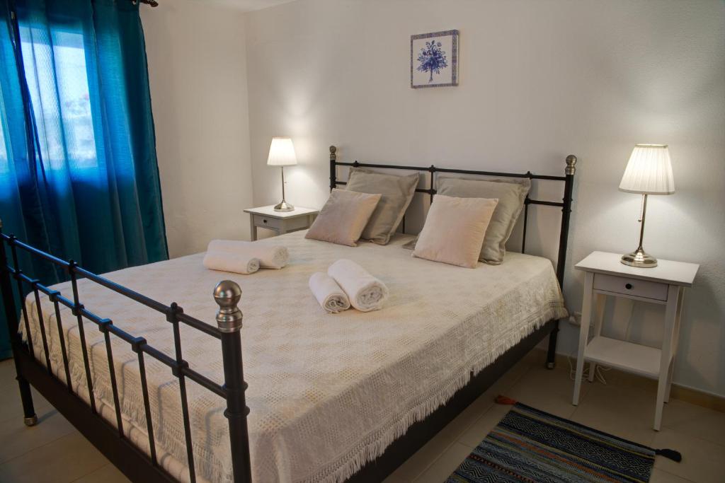 a bedroom with a bed with two pillows on it at CASA GRAZINA in Boliqueime