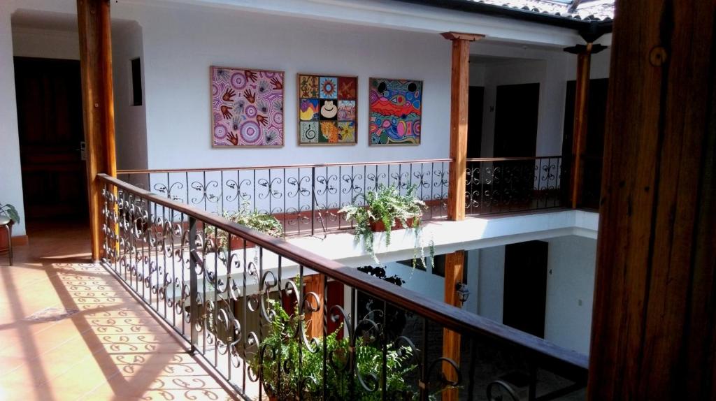 a balcony with some paintings on the wall at Cuenca Suites in Cuenca