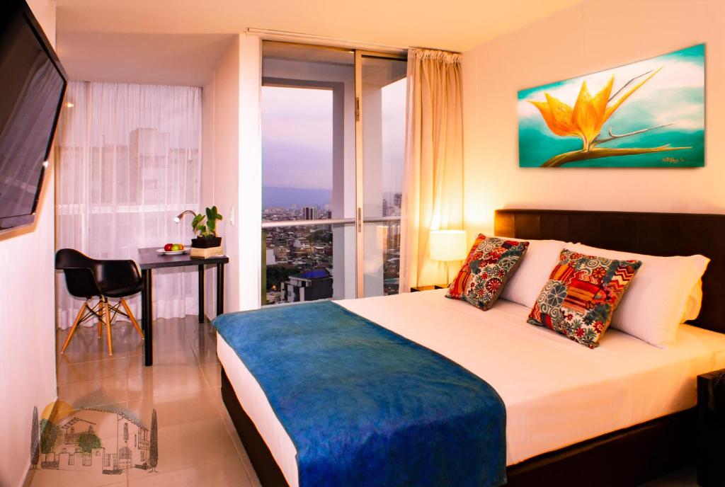 a hotel room with a bed and a view of the city at Amoblados Casa de Pinos Bucaramanga in Bucaramanga