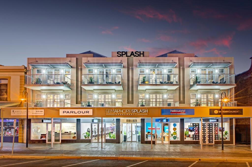 a large building with a store front at Semaphore Splash Apartments in Port Adelaide
