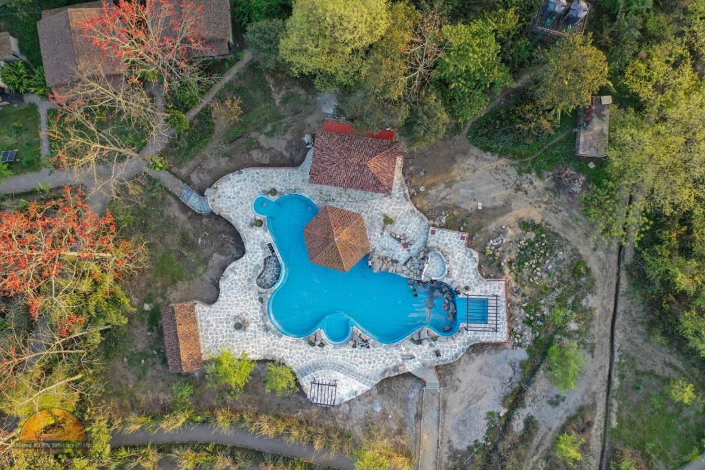 an aerial view of a yard with a swimming pool at Sarang Wildlife Sanctuary in Meghauli