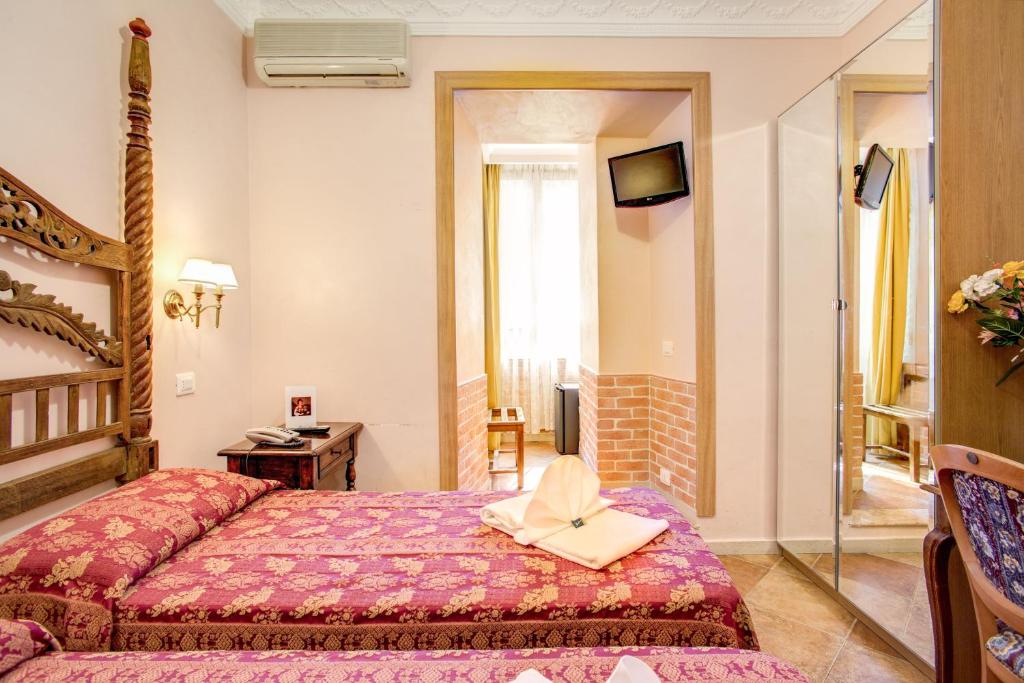Postel nebo postele na pokoji v ubytování Hotel Caravaggio