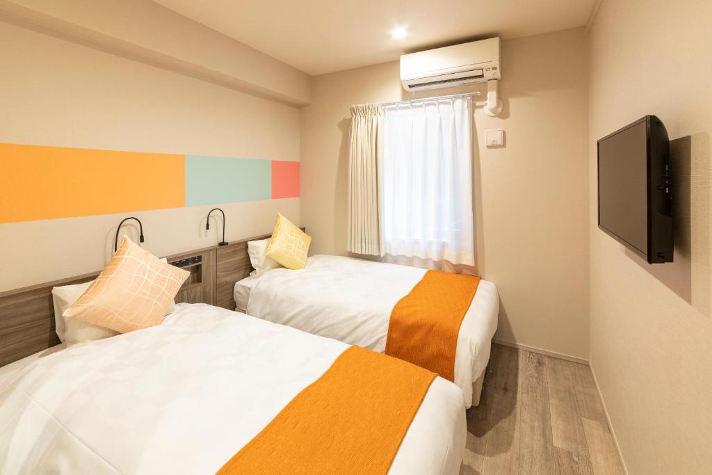 Postel nebo postele na pokoji v ubytování SARASA HOTEL Dotonbori